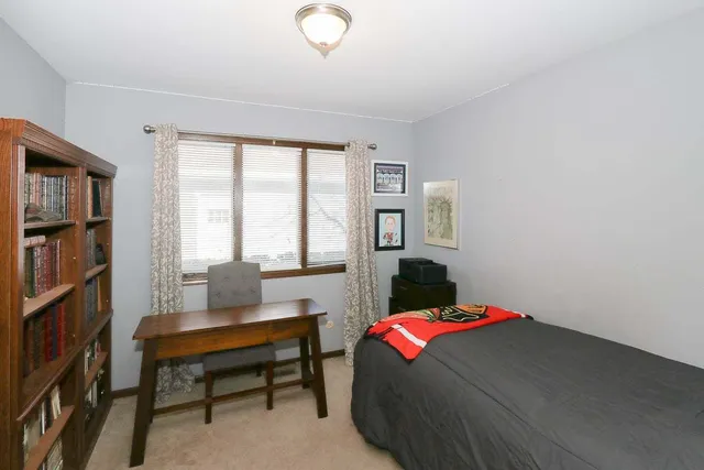 a bedroom with a bed and a book shelf