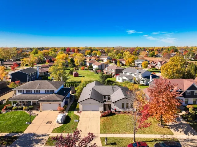 an aerial view of residential houses with outdoor space