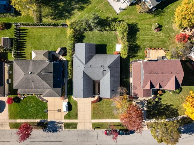 an aerial view of a house with outdoor space and lake view