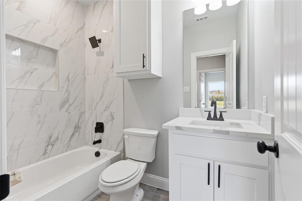 420 Ball Street Tom Bean, TX 75491 - Photo 21 of 34 a bathroom with a sink a toilet and a mirror