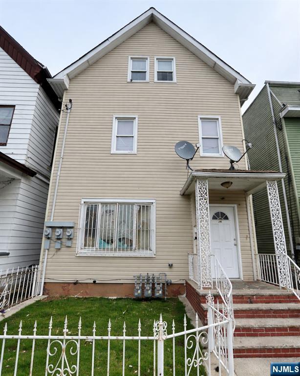 255 Franklin Street Elizabeth, NJ 07206 - Photo 1 of 34 a front view of a house with a fence