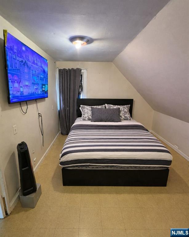 255 Franklin Street Elizabeth, NJ 07206 - Photo 2 of 34 a bedroom with bed and wooden floor