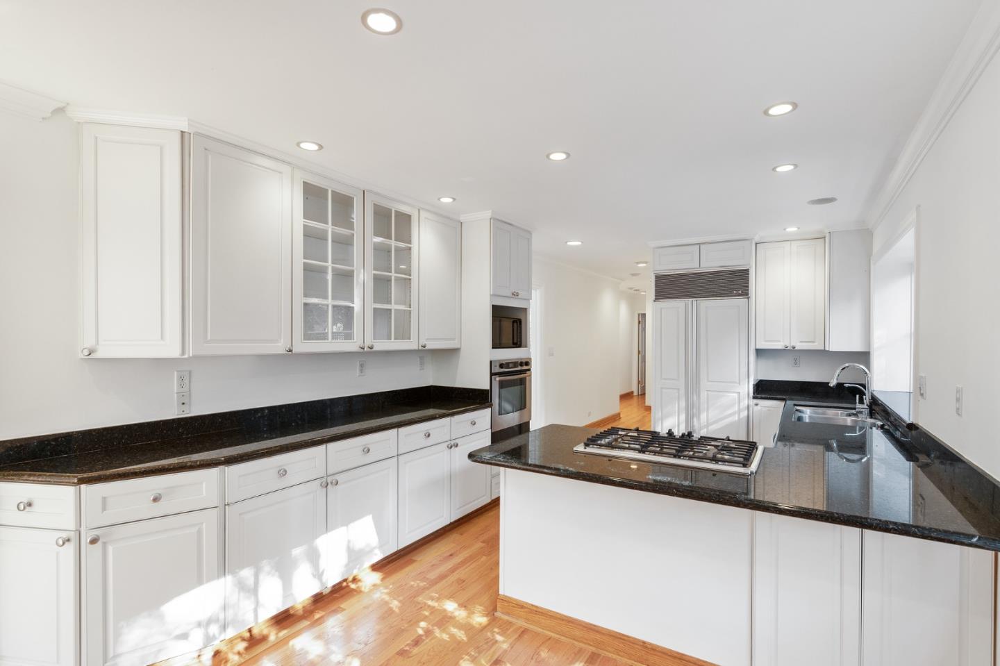 94 Palmer Lane Atherton, CA 94027 - Photo 4 of 10 a kitchen with granite countertop a sink and white cabinets