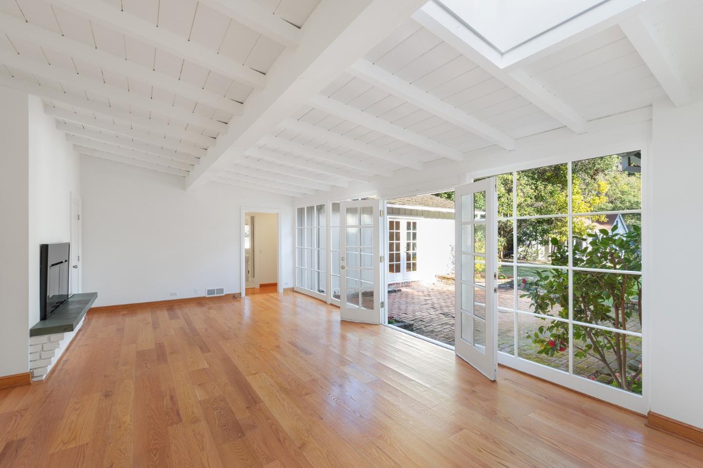 94 Palmer Lane Atherton, CA 94027 - Photo 5 of 10 an empty room with wooden floor and windows