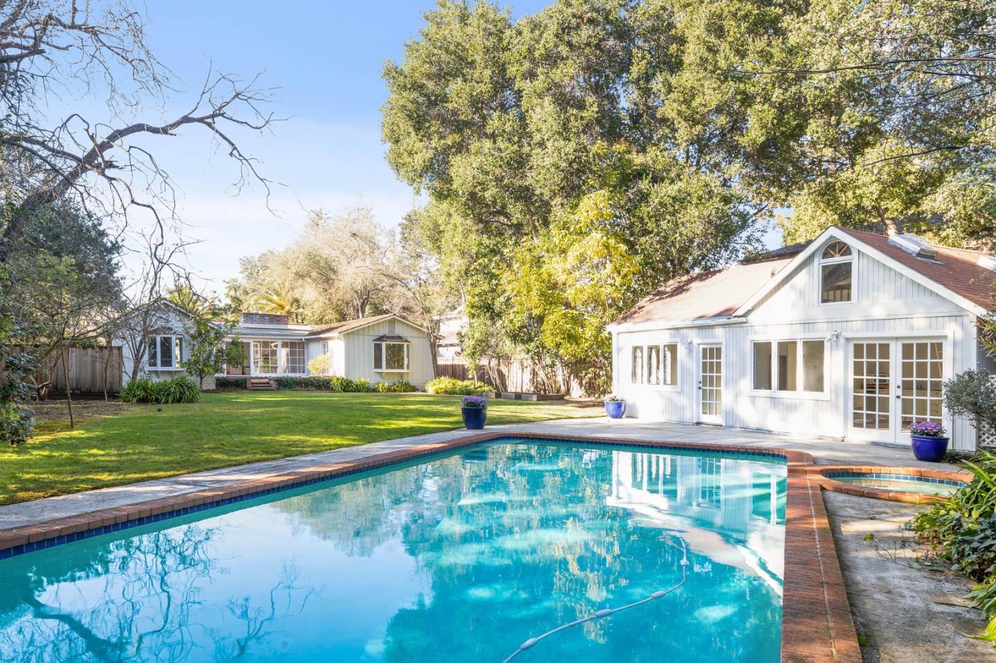 94 Palmer Lane Atherton, CA 94027 - Photo 7 of 10 a front view of a house with a yard table and chairs