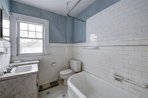 a bathroom with a sink mirror toilet and bathtub
