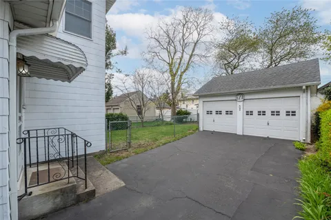 a view of a house with a yard and fence