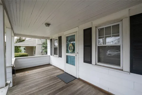 a view of an entryway with wooden floor and windows