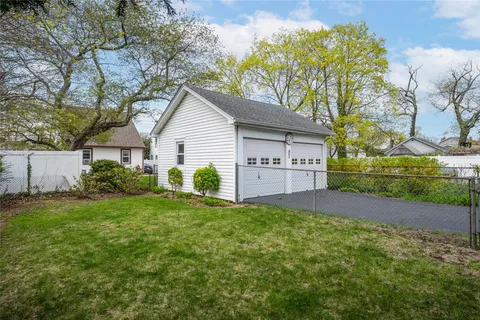 a view of a house with a yard and a garden