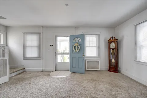 an empty room with windows and closet