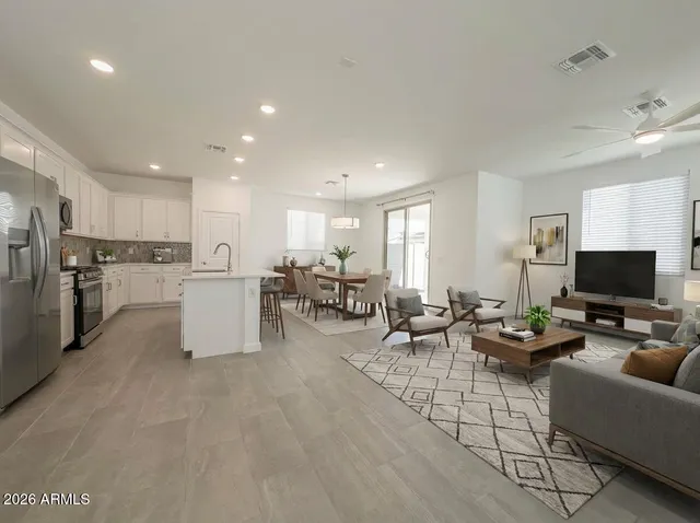 a kitchen with kitchen island a refrigerator sink and cabinets