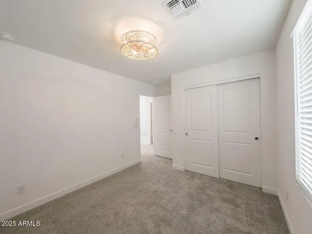 a bathroom with a double vanity sink toilet mirror and shower