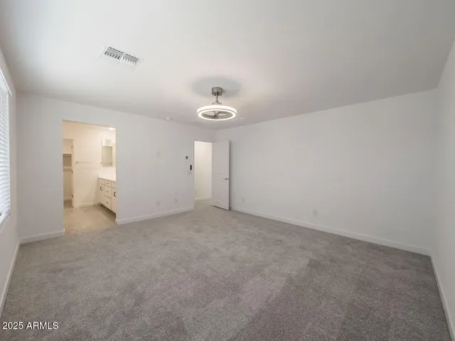 an empty room with windows and closet