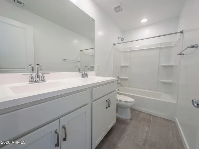 a bathroom with a double vanity sink and mirror