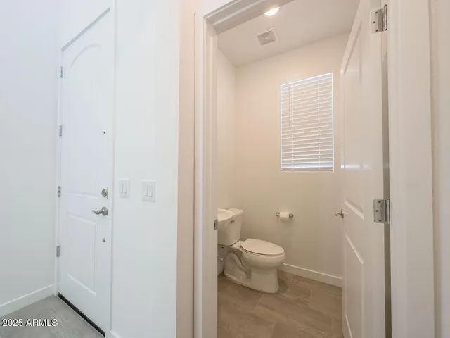 a view of a kitchen with refrigerator and white cabinets