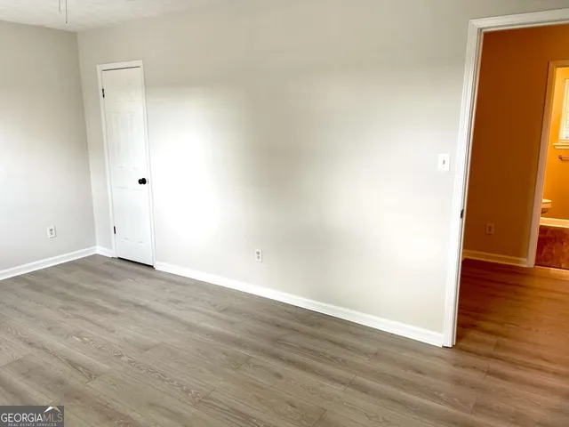 an empty room with wooden floor