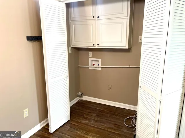 a view of a kitchen with wooden floor and cabinets