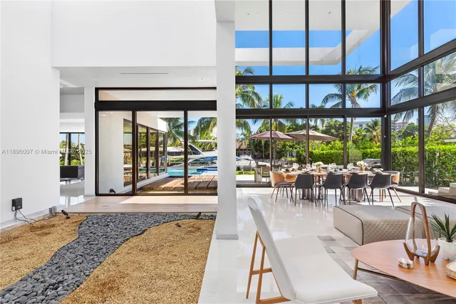 a dining room with furniture and a floor to ceiling window