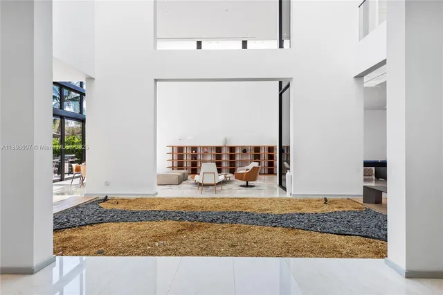 a room with pool table and windows