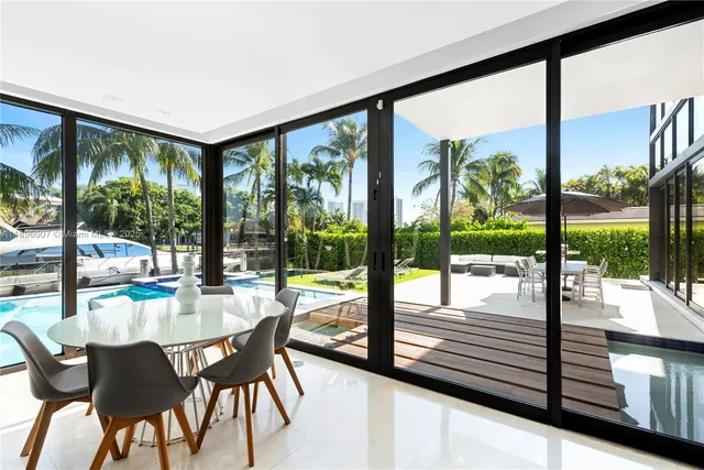 a living room with furniture flat screen tv and a large window