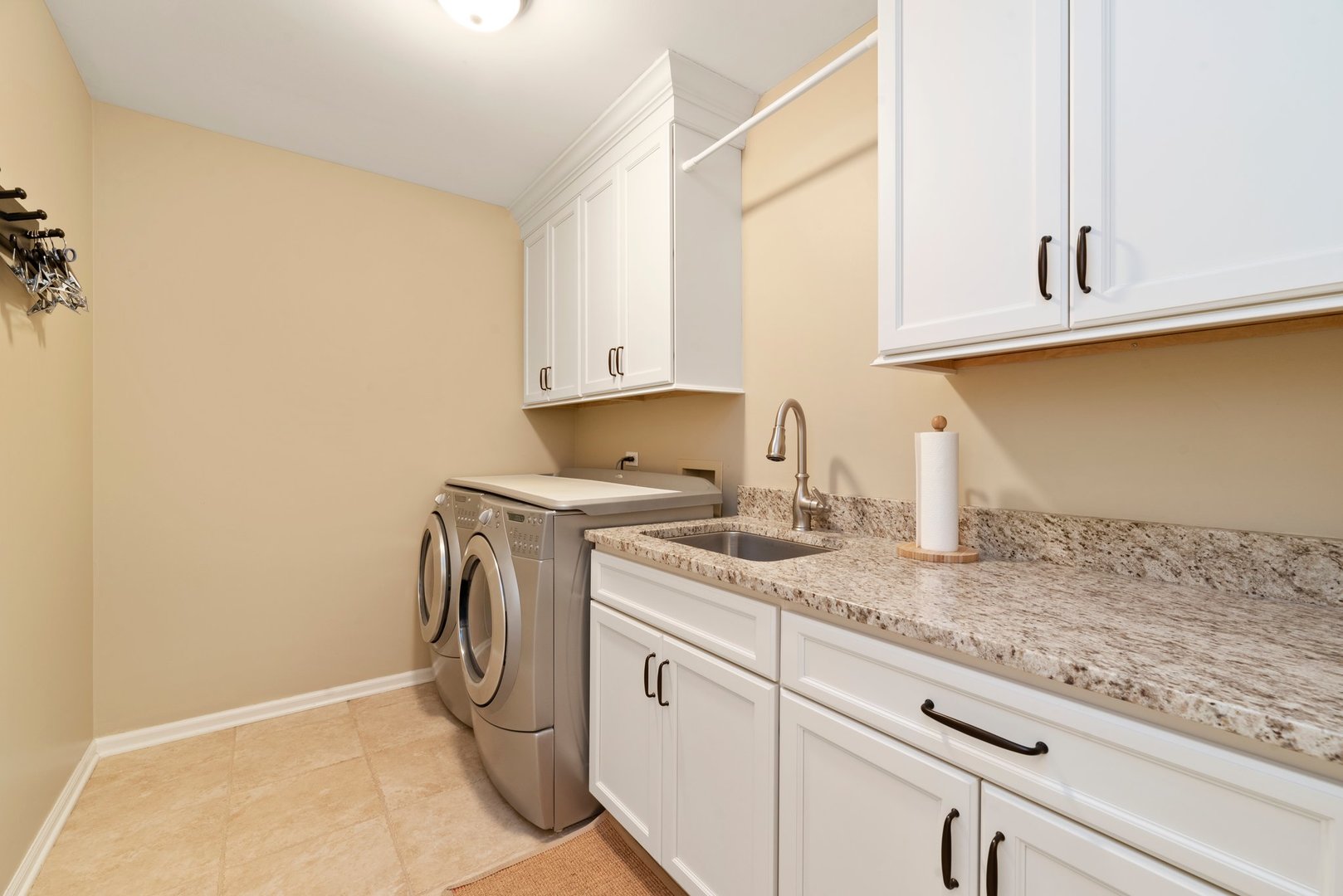 1620 Grommon Road Naperville, IL 60564 - Photo 20 of 53 a utility room with granite countertop cabinets washer and dryer