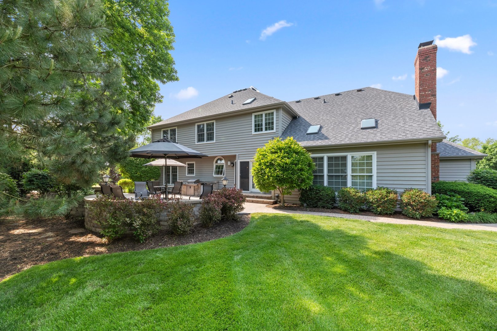 1620 Grommon Road Naperville, IL 60564 - Photo 41 of 53 a front view of a house with a garden and plants