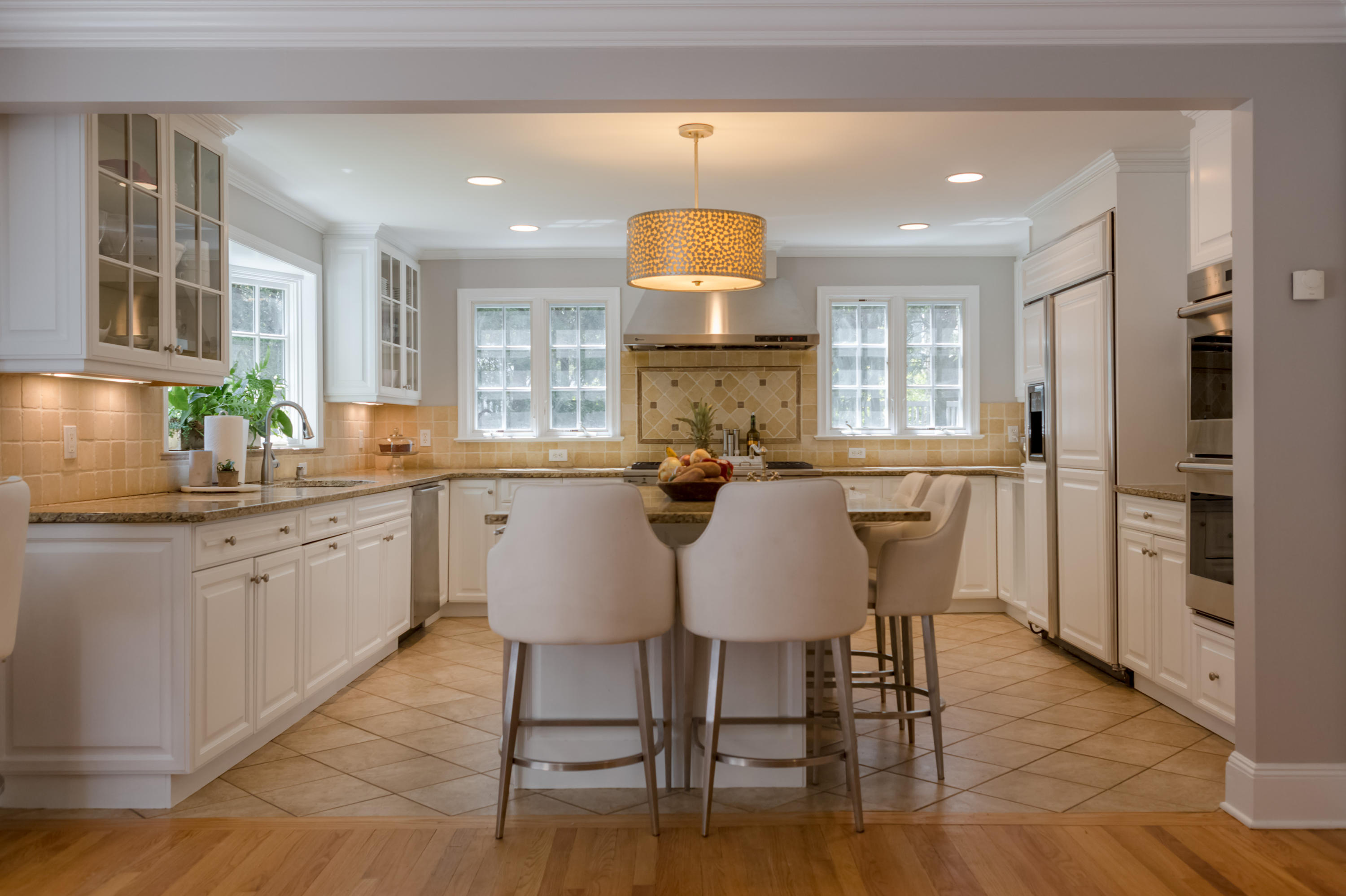 466 Mansfield Avenue Darien, CT 06820 - Photo 14 of 46 a kitchen with stainless steel appliances granite countertop a table chairs refrigerator and sink