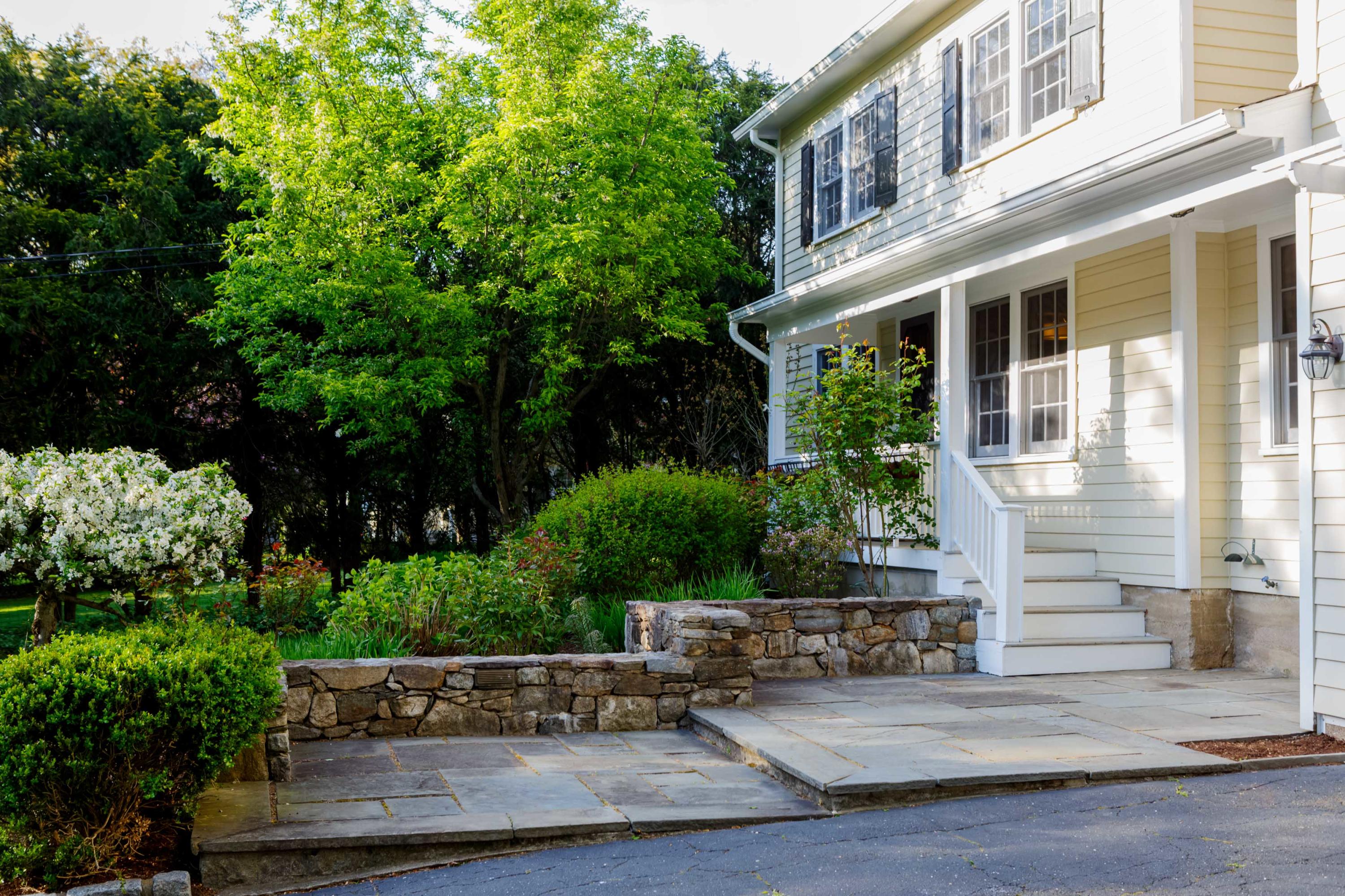 466 Mansfield Avenue Darien, CT 06820 - Photo 2 of 46 a view of a house with potted plants and a fountain