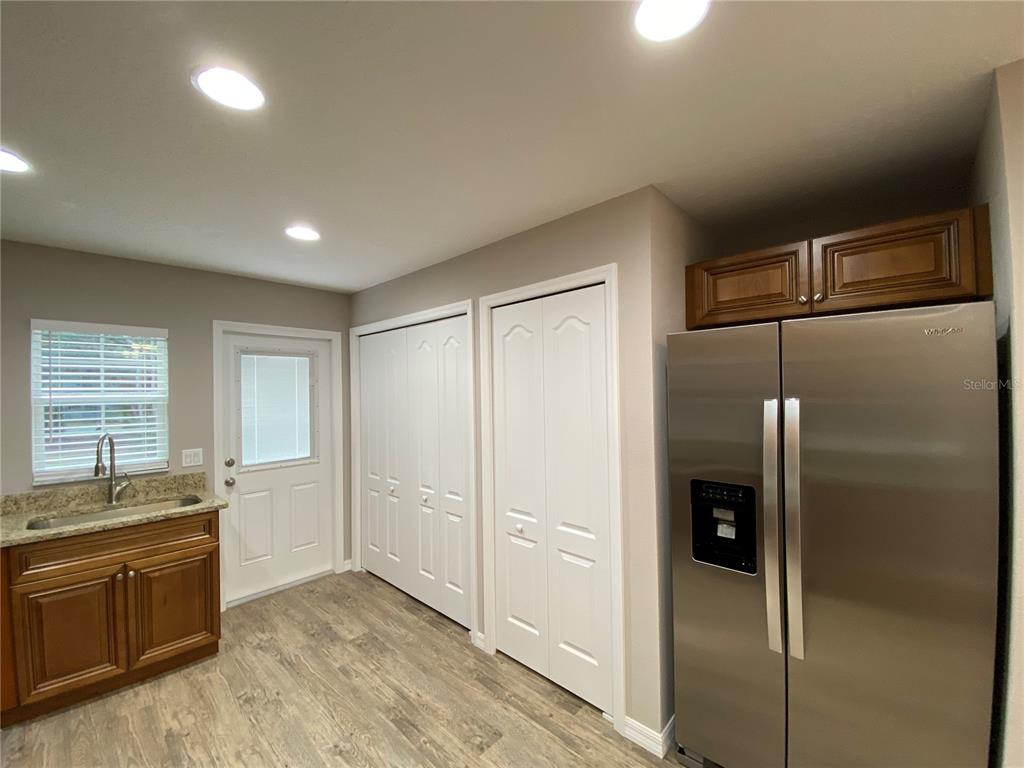 8950 North Mendoza Way Citrus Springs, FL 34434 - Photo 14 of 35 a kitchen with granite countertop a refrigerator and cabinets