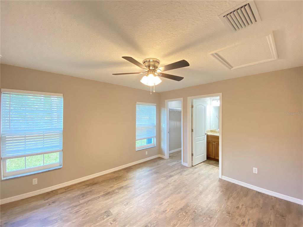 8950 North Mendoza Way Citrus Springs, FL 34434 - Photo 15 of 35 a view of an empty room with window and wooden floor