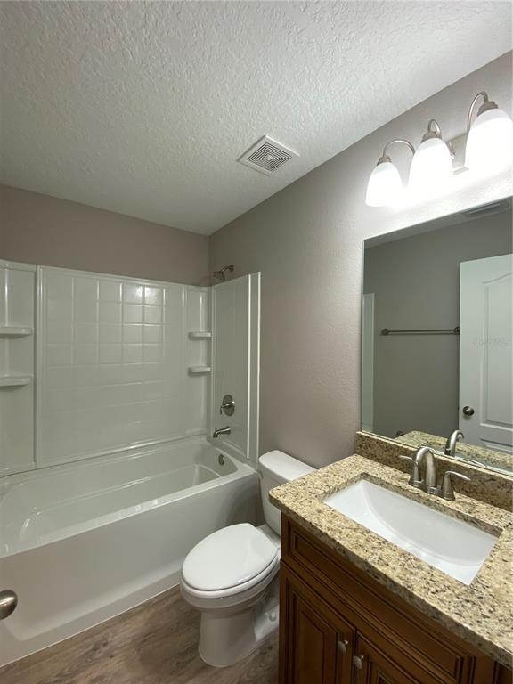 8950 North Mendoza Way Citrus Springs, FL 34434 - Photo 22 of 35 a bathroom with a granite countertop sink toilet mirror and bathtub