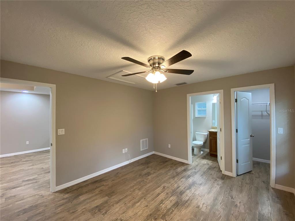 8950 North Mendoza Way Citrus Springs, FL 34434 - Photo 25 of 35 wooden floor in an empty room and a bathroom