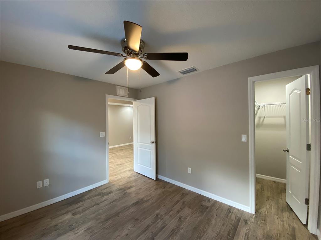 8950 North Mendoza Way Citrus Springs, FL 34434 - Photo 29 of 35 wooden floor in an empty room with a bathroom