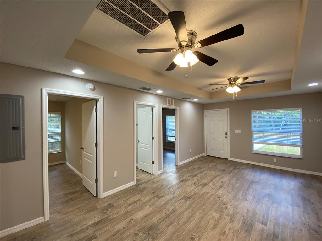8950 North Mendoza Way Citrus Springs, FL 34434 - Photo 5 of 35 a view of an empty room with a window and wooden floor