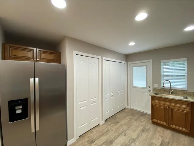 a kitchen with stainless steel appliances granite countertop a refrigerator and a sink