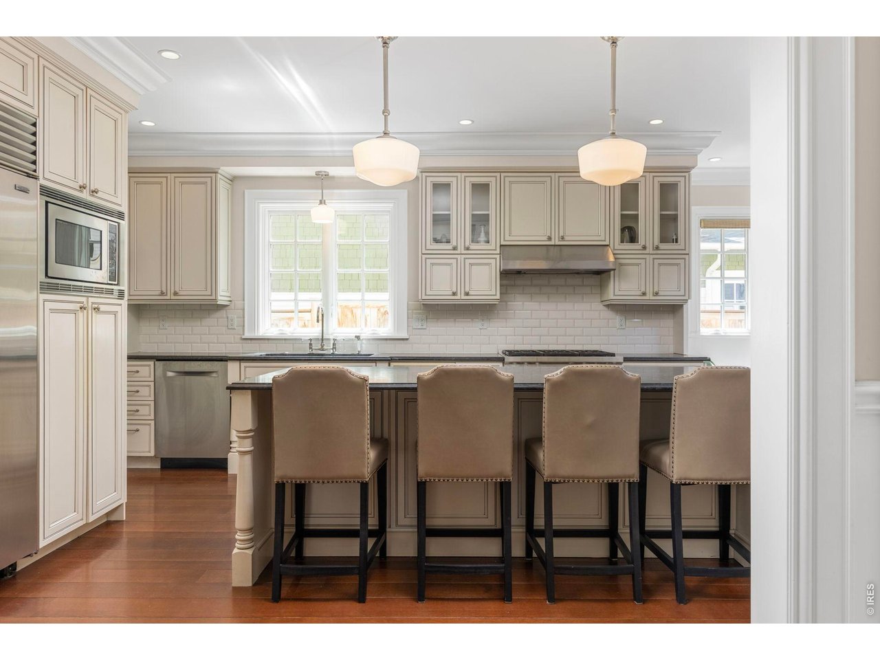 3181 9th Street Boulder, CO 80304 - Photo 12 of 49 a kitchen with granite countertop a table chairs sink and cabinets