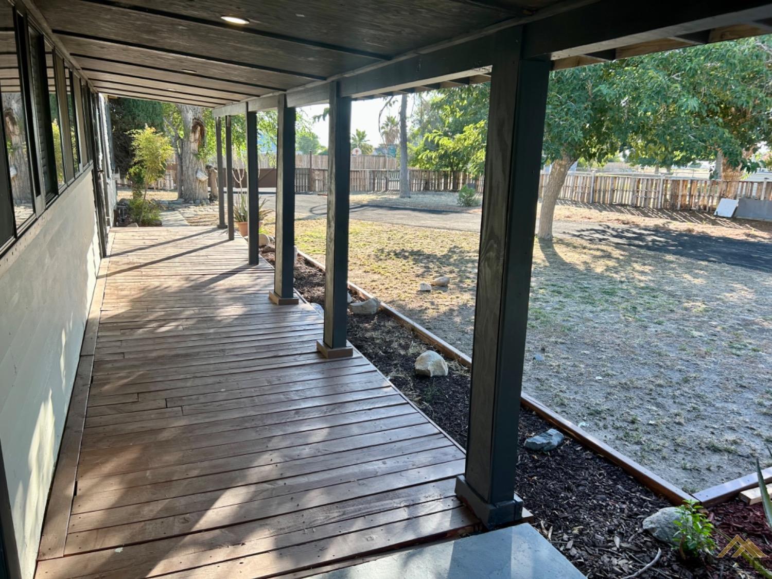 Undisclosed Address Maricopa, CA 93252 - Photo 15 of 32 a view of a porch with wooden floor and outdoor seating