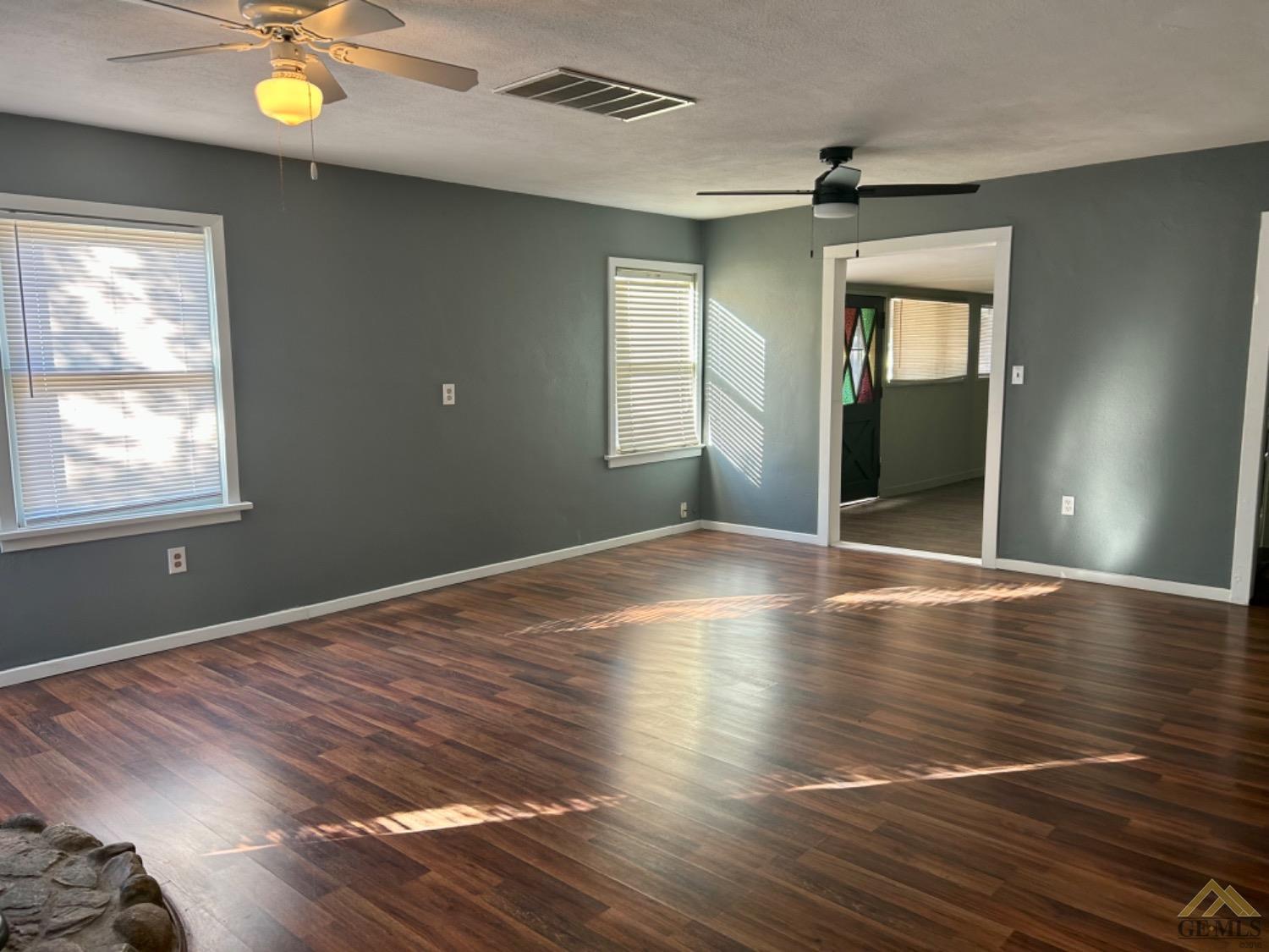 Undisclosed Address Maricopa, CA 93252 - Photo 18 of 32 a view of an empty room with wooden floor and a window