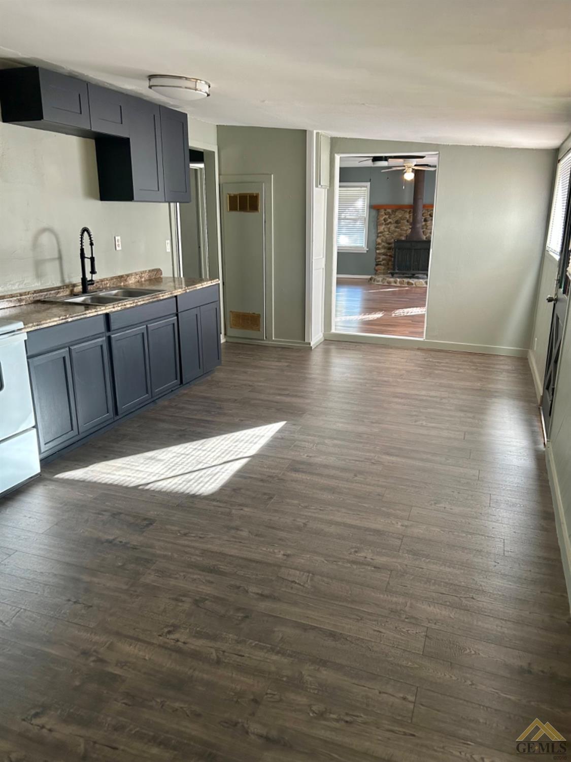 Undisclosed Address Maricopa, CA 93252 - Photo 22 of 32 a view of a kitchen with stainless steel appliances wooden floor and chair