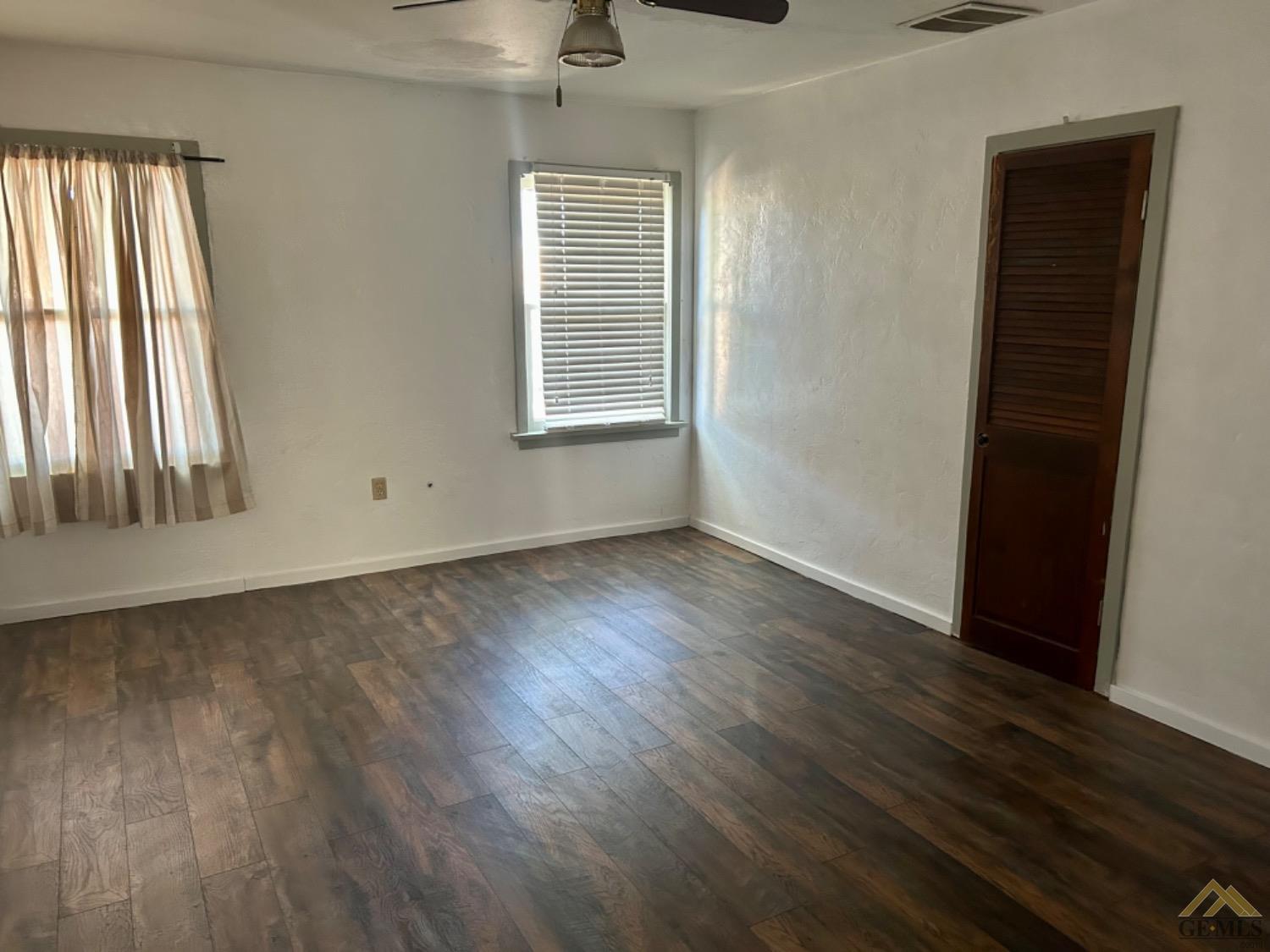 Undisclosed Address Maricopa, CA 93252 - Photo 24 of 32 an empty room with wooden floor and windows