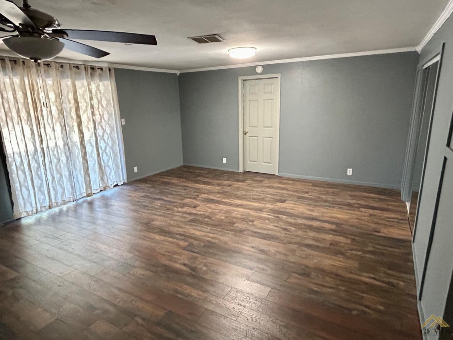 Undisclosed Address Maricopa, CA 93252 - Photo 26 of 32 an empty room with wooden floor and windows