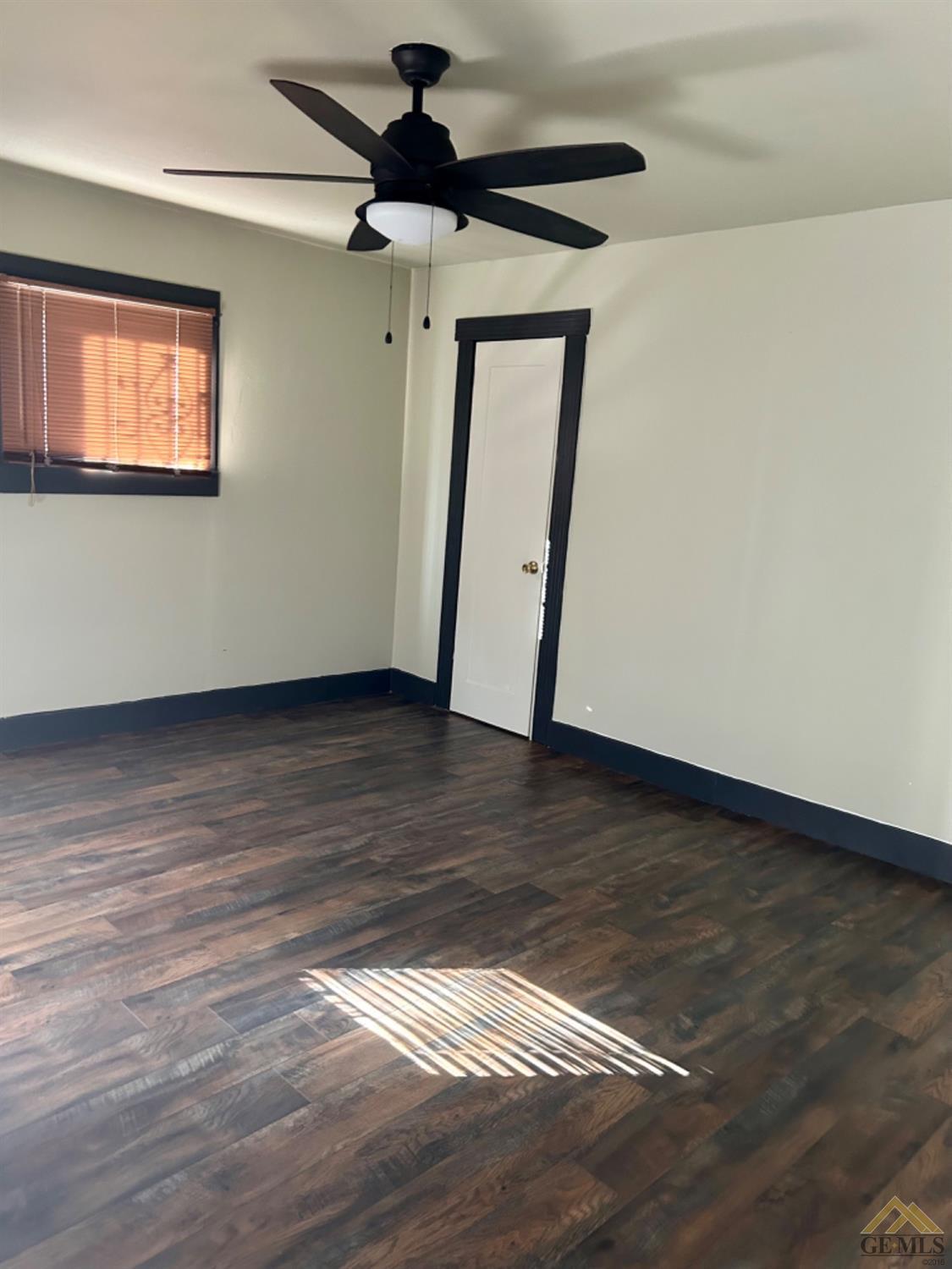 Undisclosed Address Maricopa, CA 93252 - Photo 31 of 32 a view of an empty room with wooden floor and a window