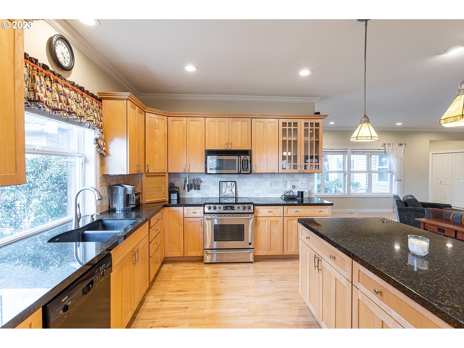 28179 High Pass Road Junction City, OR 97448 - Photo 13 of 48 a kitchen with stainless steel appliances granite countertop a sink a stove and a wooden cabinets