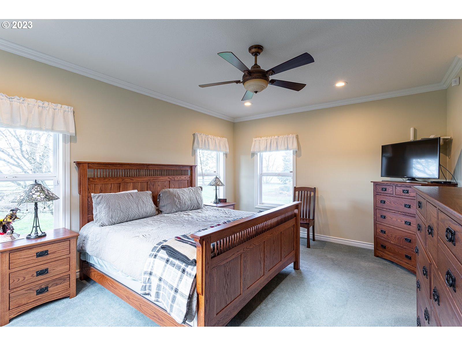 28179 High Pass Road Junction City, OR 97448 - Photo 29 of 48 a bedroom with a bed and a flat screen tv