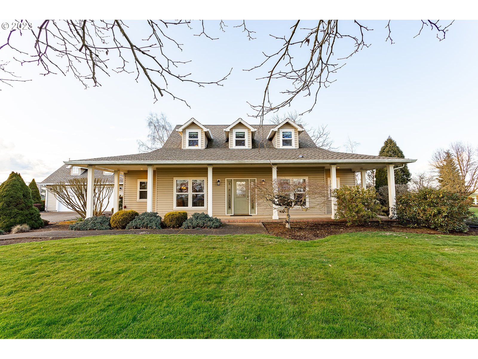 28179 High Pass Road Junction City, OR 97448 - Photo 6 of 48 a front view of a house with a garden and patio