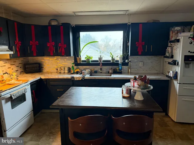 a kitchen with a sink a stove and a wooden cabinets