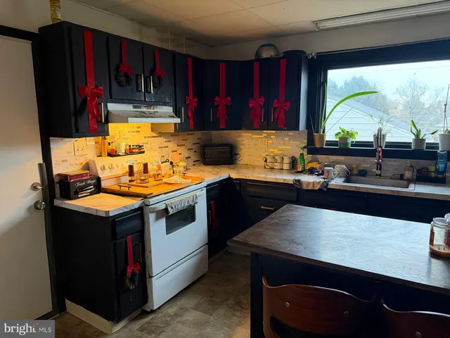 a kitchen with a sink and a stove top oven