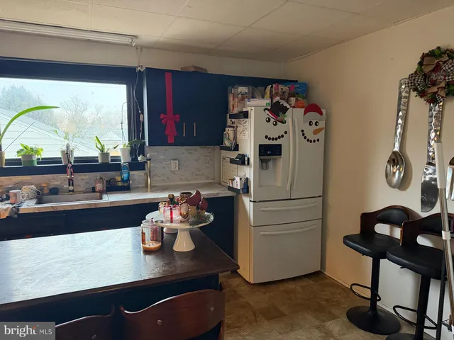 a kitchen with a refrigerator and a stove
