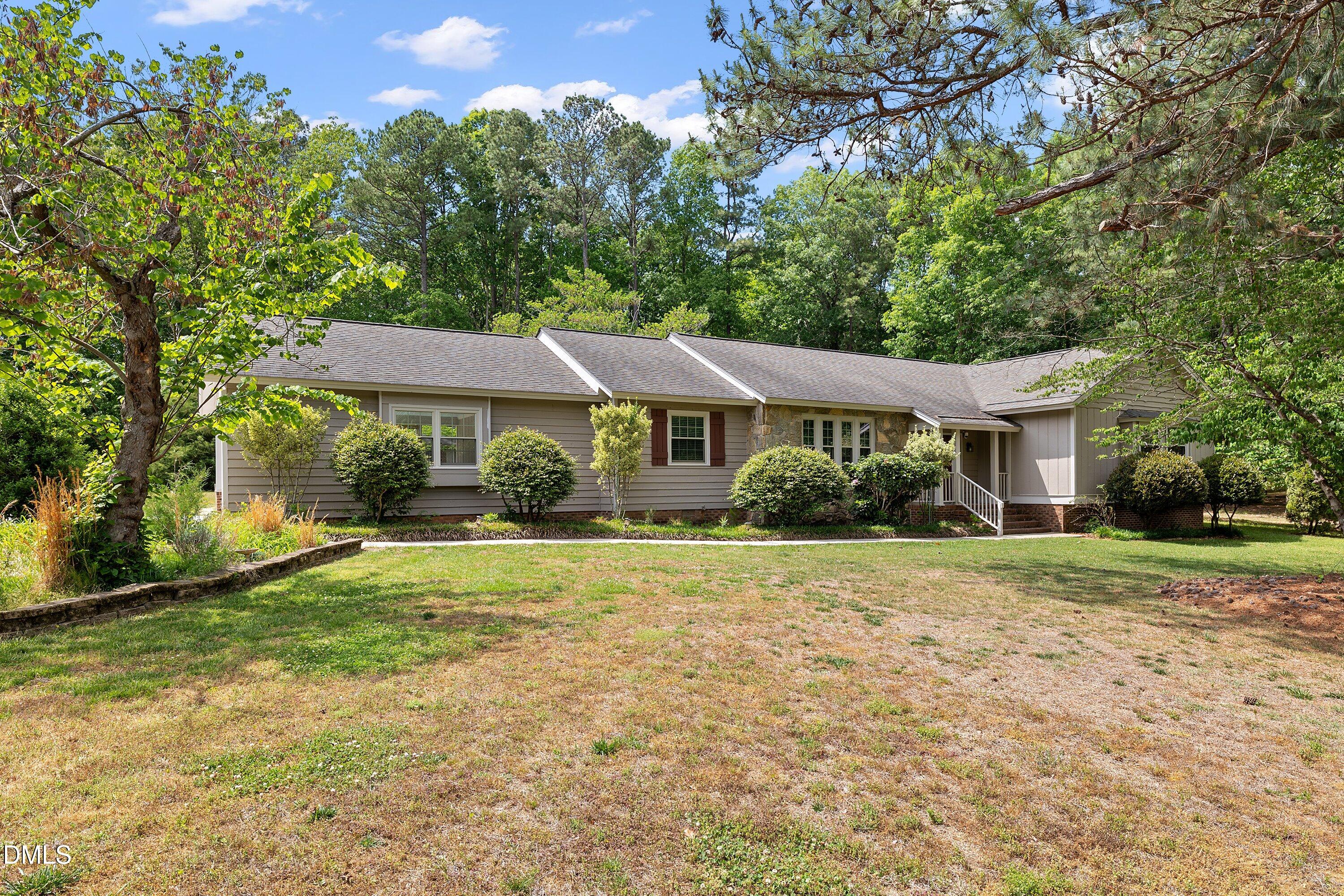 8133 Holly Forest Road Wake Forest, NC 27587 - Photo 3 of 50 a front view of a house with garden