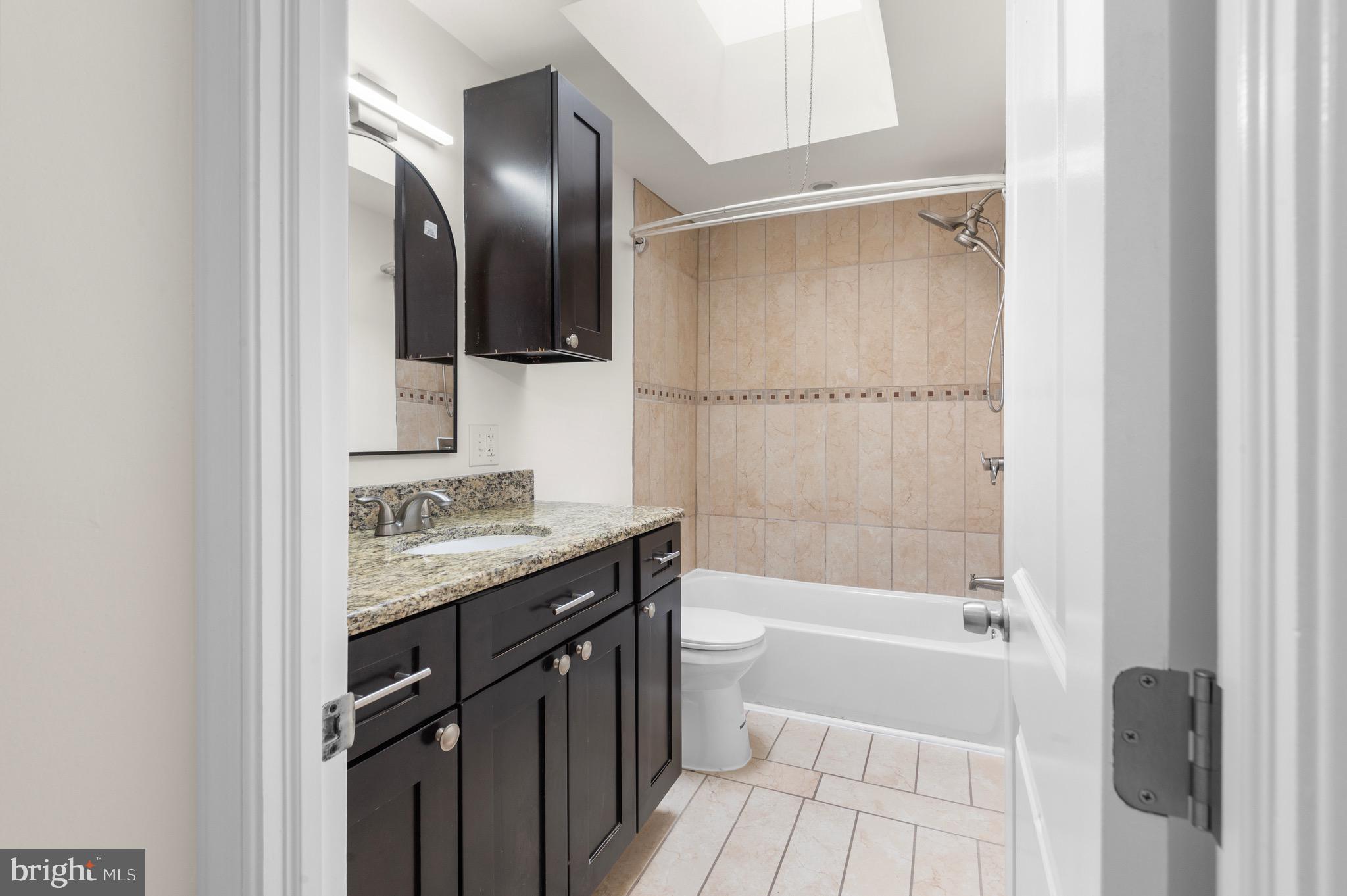10867 Harrow Road Philadelphia, PA 19154 - Photo 16 of 19 a bathroom with a granite countertop sink toilet and shower